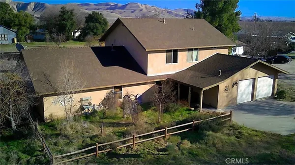 an aerial view of a house with a yard