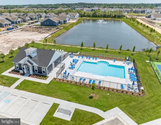 an aerial view of a house with a garden and lake view