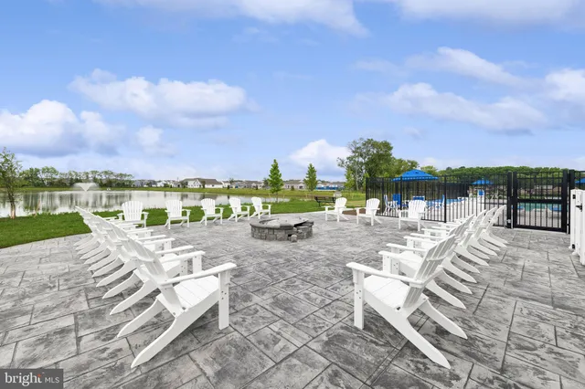 a view of swimming pool with lounge chair in front of house