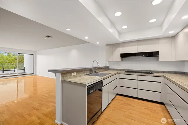 a kitchen with a sink stove and cabinets