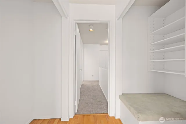 a view of a bedroom with wooden floor and cabinet