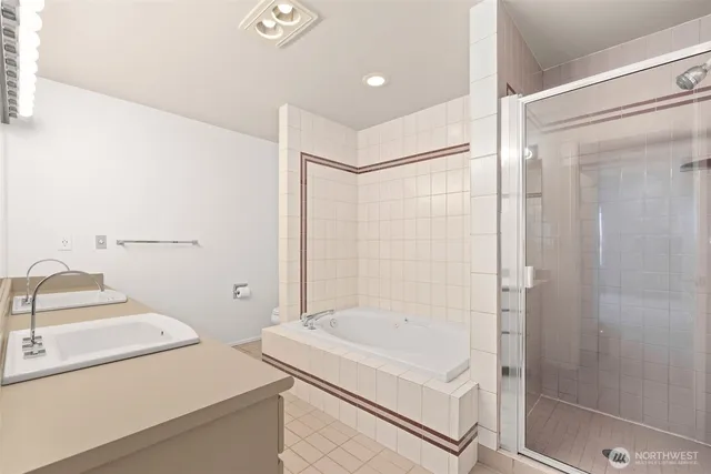 a bathroom with a tub and a shower