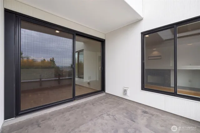 a view of a room with a glass door and glass window