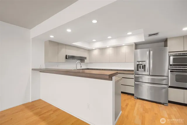a kitchen with stainless steel appliances a refrigerator and a sink