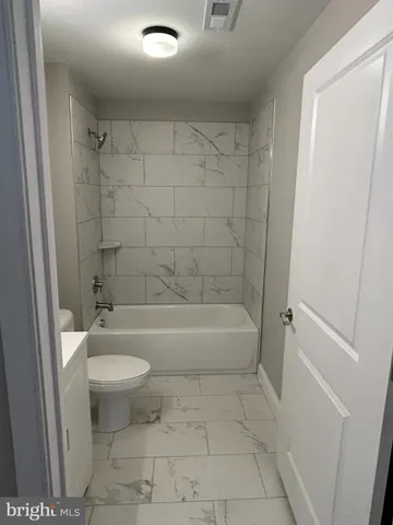 a bathroom with a bathtub a toilet and a shower