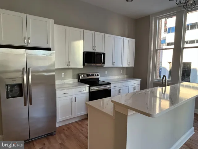 a kitchen with a refrigerator sink and microwave