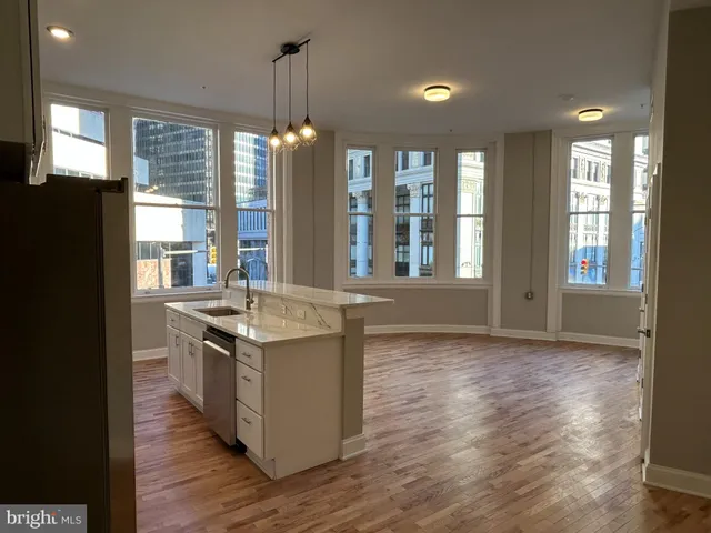 a kitchen with stainless steel appliances granite countertop a stove and a refrigerator
