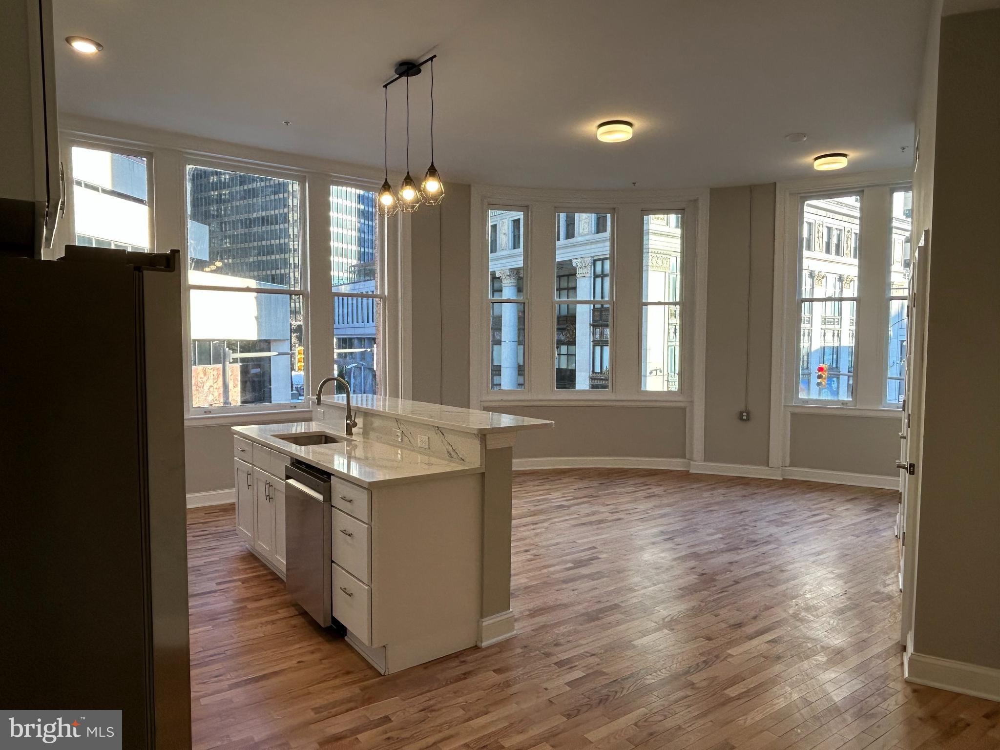 100 West Lexington Street, Unit 301 Baltimore, MD 21201 - Photo 3 of 30 a kitchen with stainless steel appliances granite countertop a stove and a refrigerator