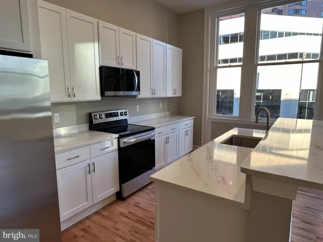 a kitchen with a sink a stove and cabinets