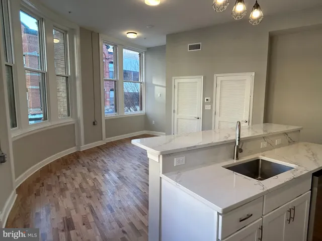 a kitchen with a sink and a mirror