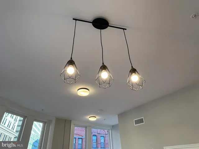 a view of a chandelier fan and windows