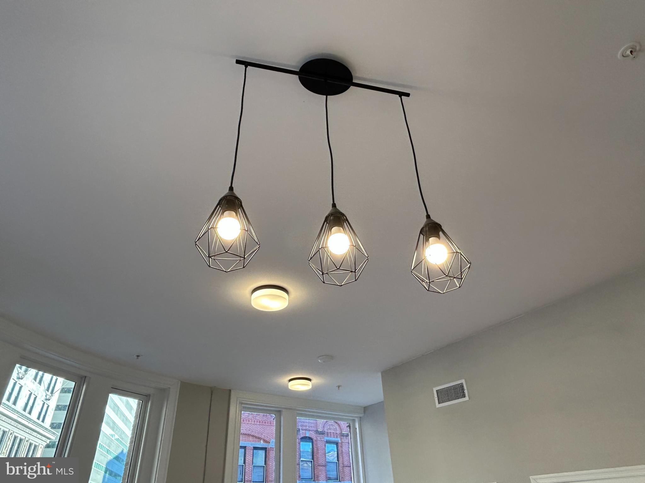 100 West Lexington Street, Unit 301 Baltimore, MD 21201 - Photo 7 of 30 a view of a chandelier fan and windows