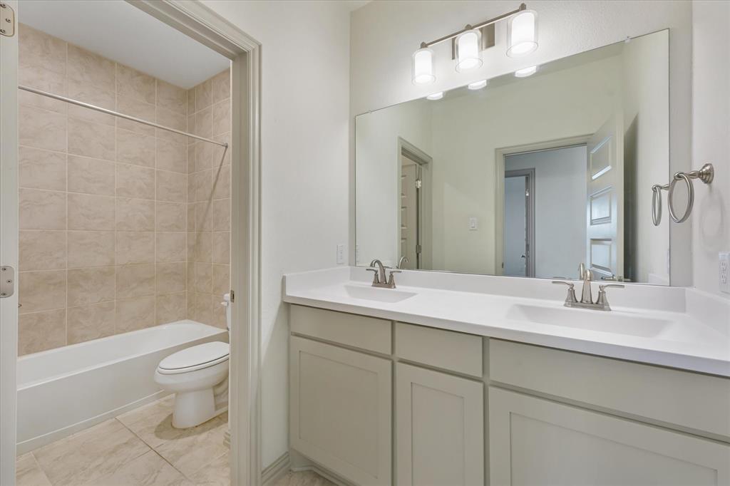 3208 Heathrow Road Mesquite, TX 75181 - Photo 16 of 21 a bathroom with a double vanity sink toilet and shower