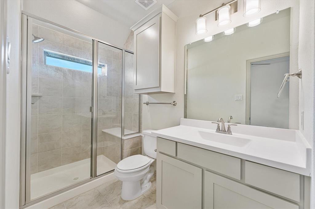 3208 Heathrow Road Mesquite, TX 75181 - Photo 18 of 21 a bathroom with a sink a toilet and shower