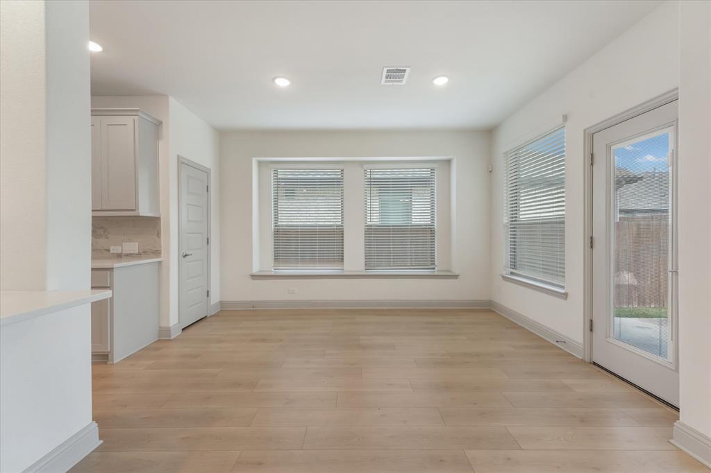 3208 Heathrow Road Mesquite, TX 75181 - Photo 4 of 21 a view of an empty room with a kitchen