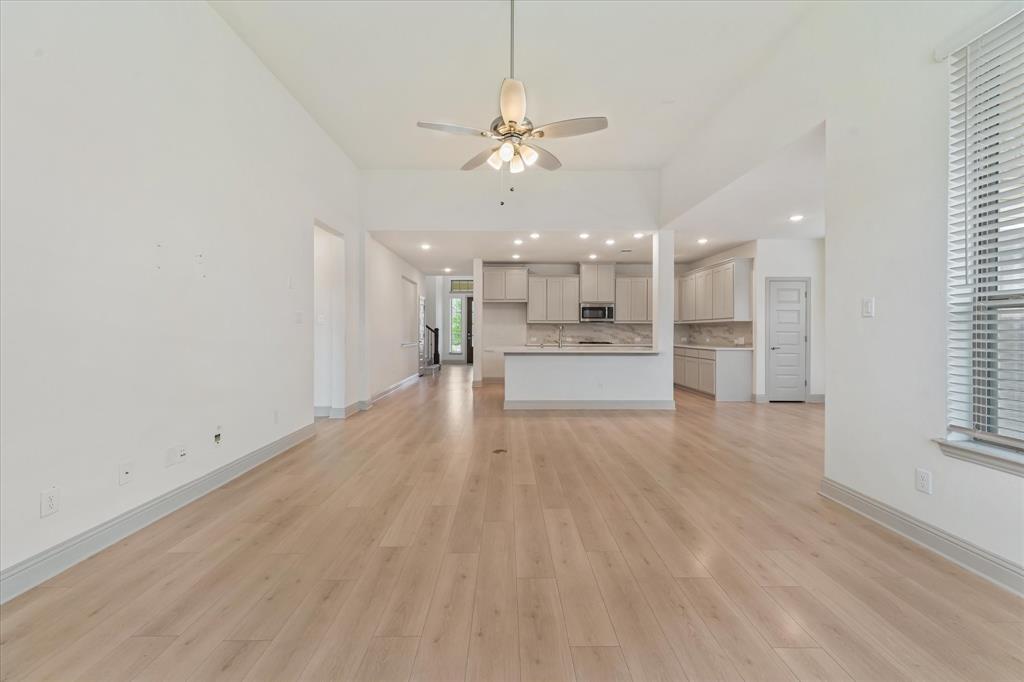 3208 Heathrow Road Mesquite, TX 75181 - Photo 5 of 21 a view of a kitchen with a sink and dishwasher a refrigerator with wooden floor