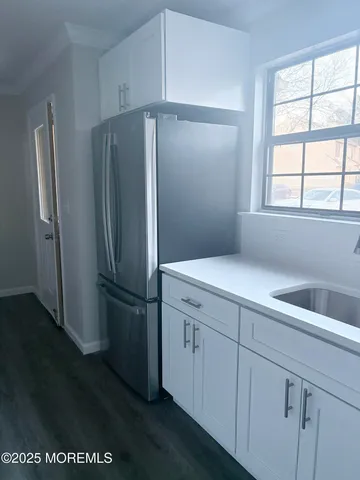 a kitchen with cabinets and stainless steel appliances