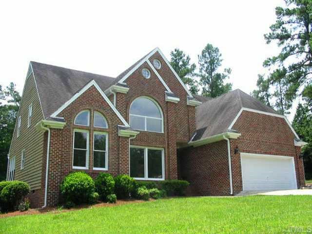 2008 Hilly Ridge Raleigh, NC 27603 - Photo 1 of 10 a front view of a house with a yard and garage