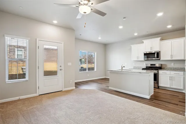 a view of kitchen with windows and ceiling fan