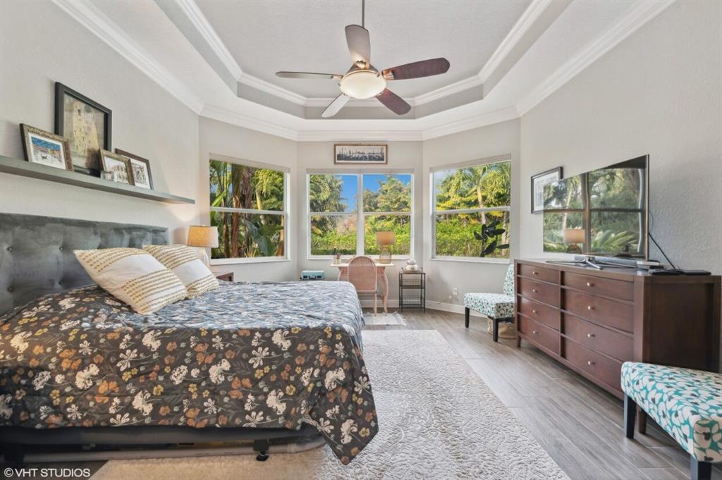 7619 Southeast Belle Maison Drive Stuart, FL 34997 - Photo 12 of 44 a bedroom with a large bed and a window