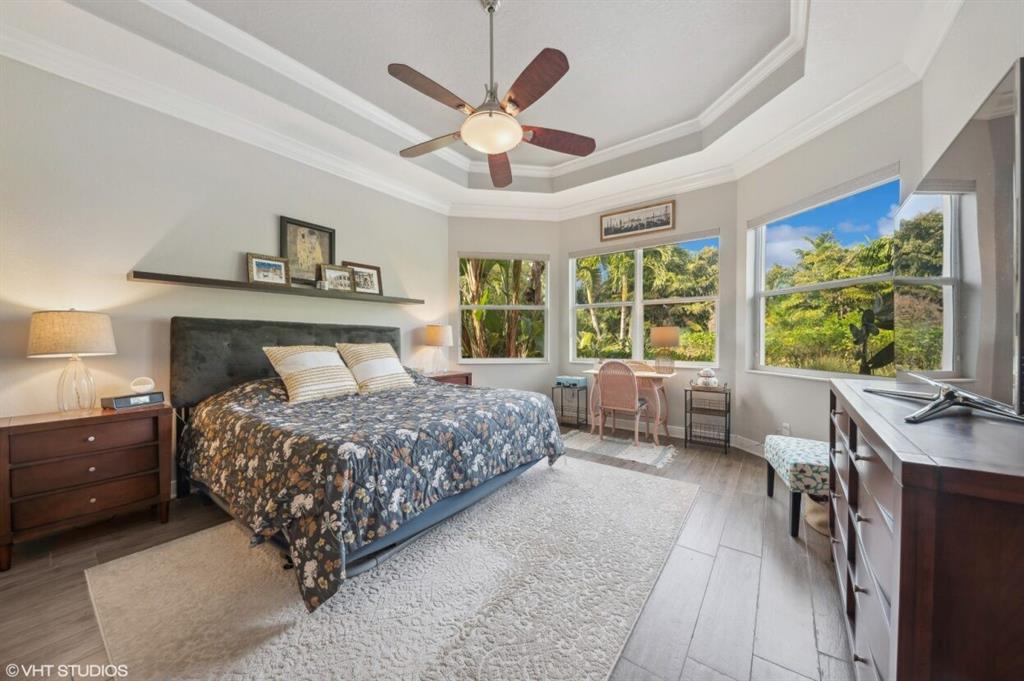 7619 Southeast Belle Maison Drive Stuart, FL 34997 - Photo 13 of 44 a bedroom with a large bed and a large window