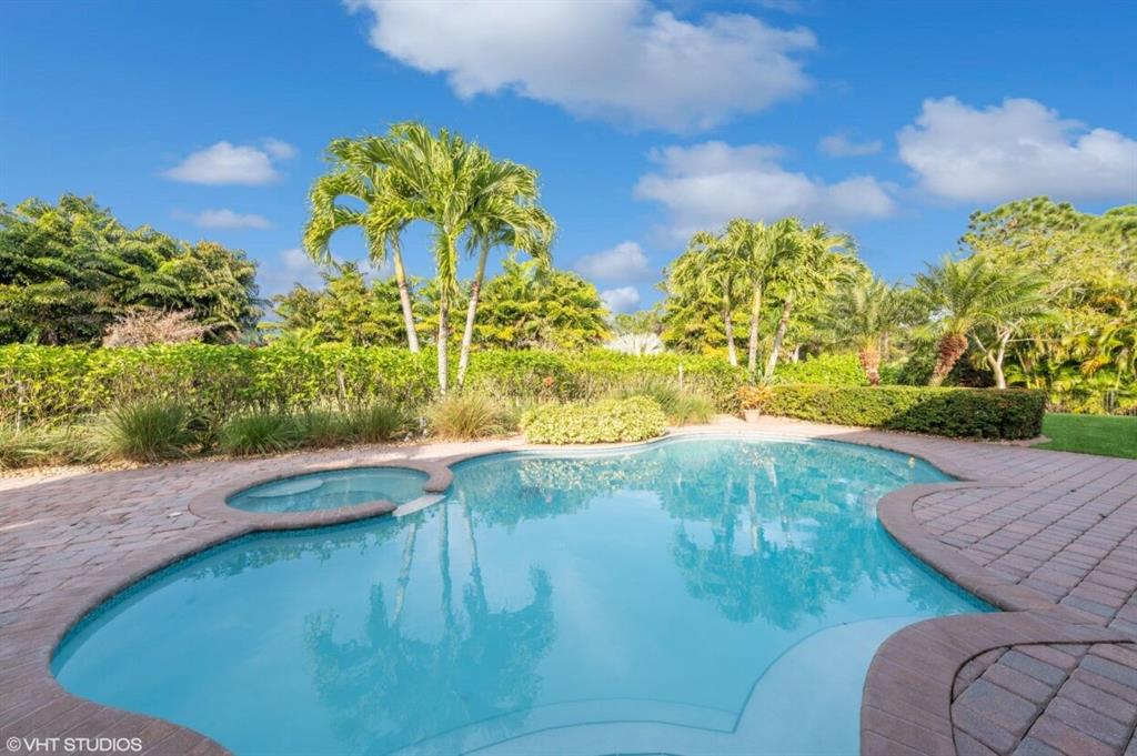 7619 Southeast Belle Maison Drive Stuart, FL 34997 - Photo 23 of 44 a view of a swimming pool with a yard