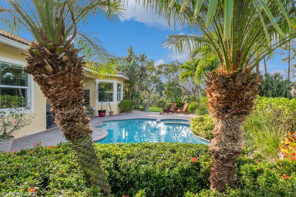 7619 Southeast Belle Maison Drive Stuart, FL 34997 - Photo 26 of 44 a view of a house with a yard