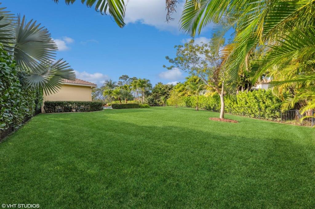 7619 Southeast Belle Maison Drive Stuart, FL 34997 - Photo 29 of 44 a view of a garden with a building in the background