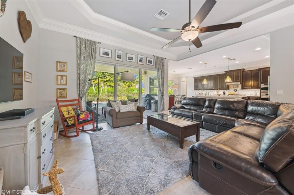 7619 Southeast Belle Maison Drive Stuart, FL 34997 - Photo 3 of 44 a living room with furniture kitchen view and a large window