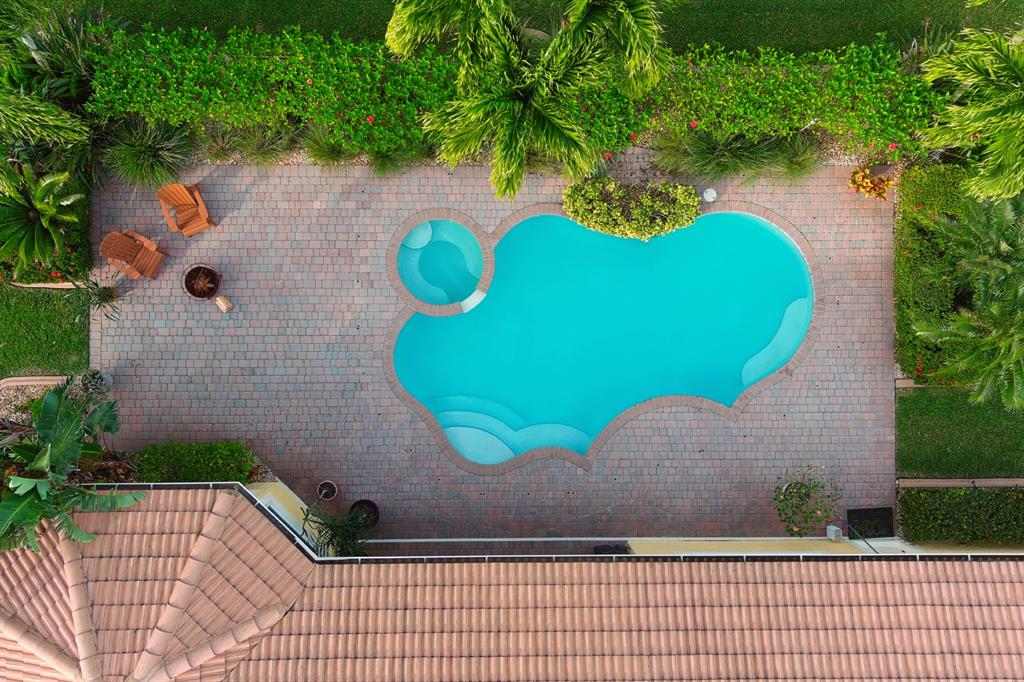 7619 Southeast Belle Maison Drive Stuart, FL 34997 - Photo 31 of 44 a view of a wooden door with a bench in the patio