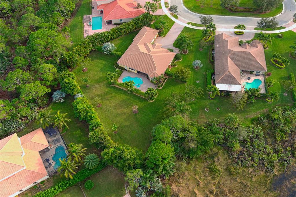 7619 Southeast Belle Maison Drive Stuart, FL 34997 - Photo 34 of 44 an aerial view of a house with garden space and street view