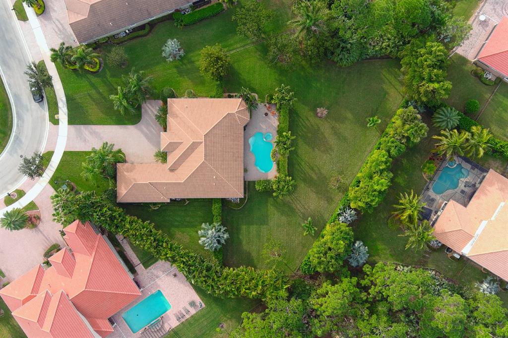 7619 Southeast Belle Maison Drive Stuart, FL 34997 - Photo 40 of 44 an aerial view of a house with a yard and lake view