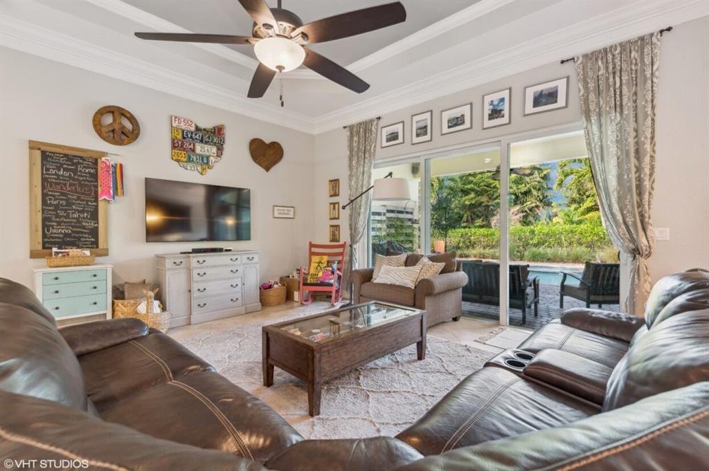 7619 Southeast Belle Maison Drive Stuart, FL 34997 - Photo 4 of 44 a living room with fireplace furniture and a flat screen tv