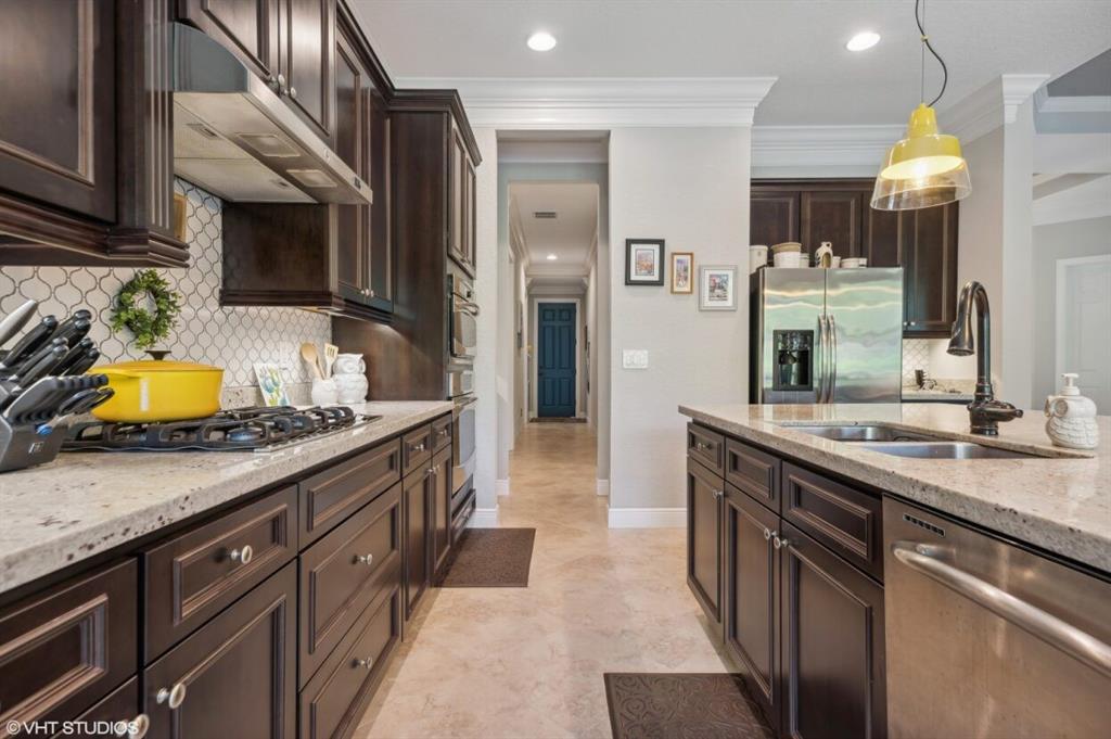 7619 Southeast Belle Maison Drive Stuart, FL 34997 - Photo 6 of 44 a kitchen with stainless steel appliances granite countertop a stove and a sink