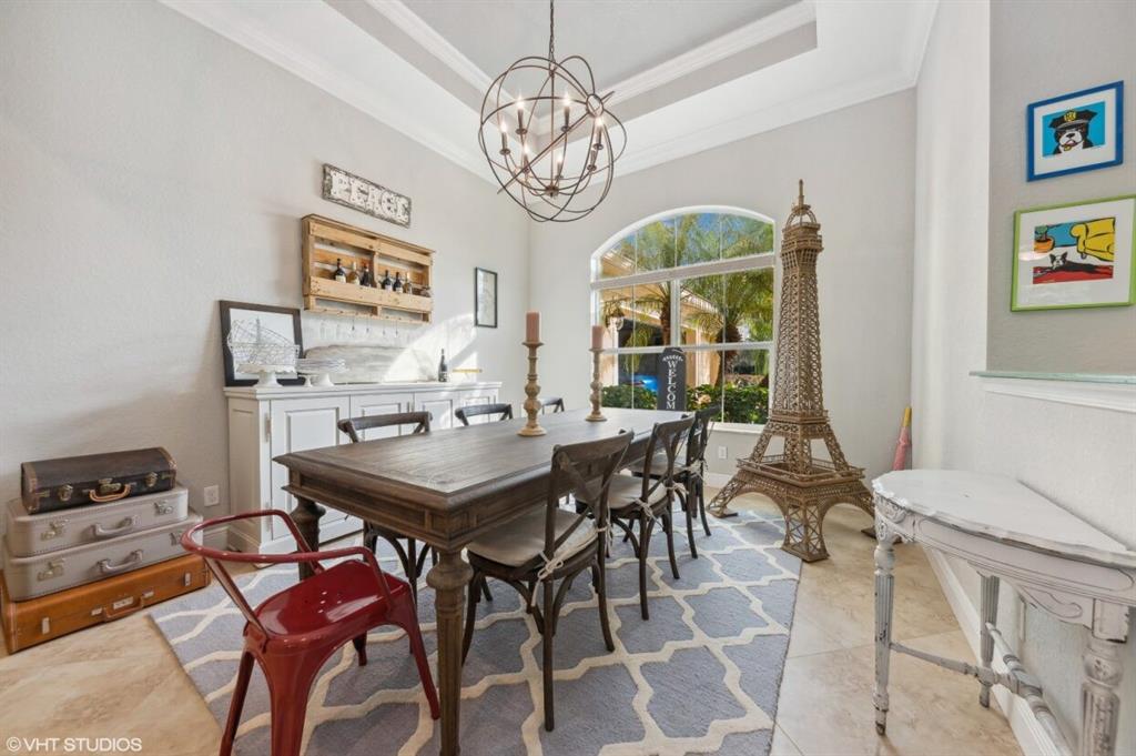 7619 Southeast Belle Maison Drive Stuart, FL 34997 - Photo 10 of 44 a view of a dining room with furniture and chandelier