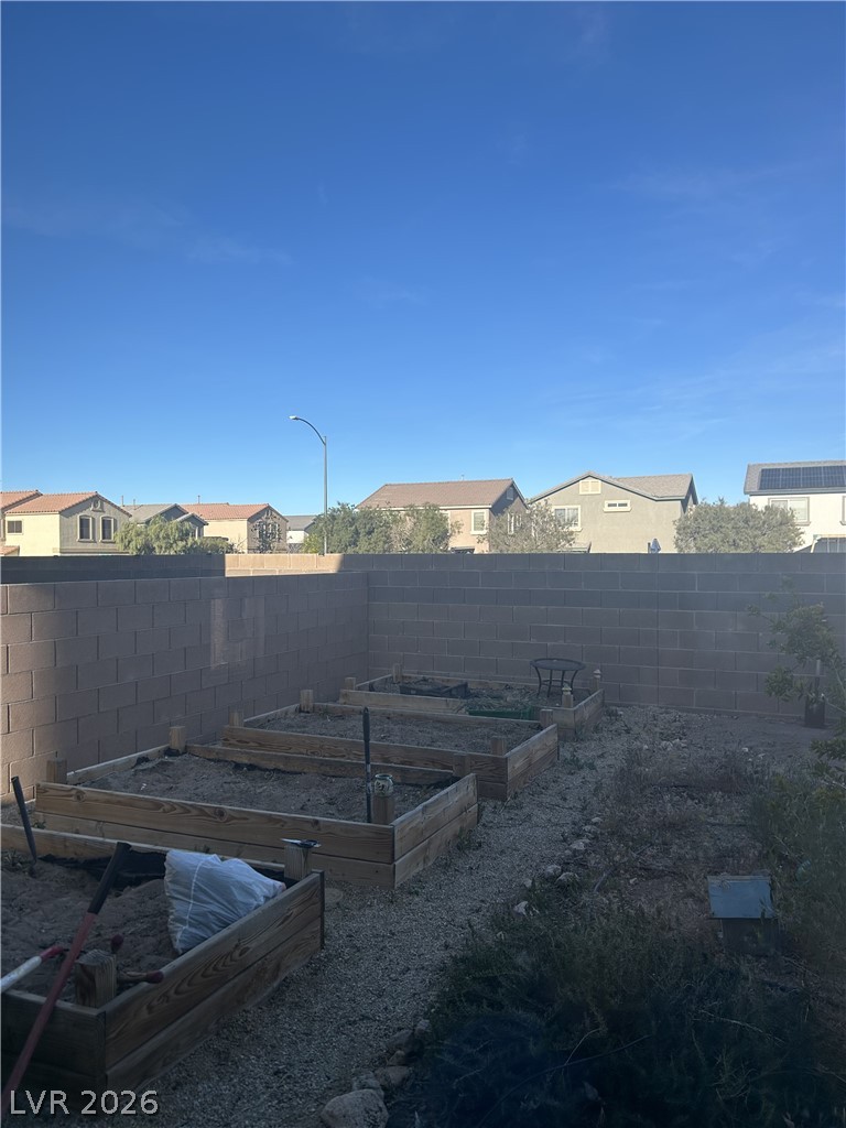 10638 Adobe Rnch Street Las Vegas, NV 89141 - Photo 23 of 35 Fenced backyard featuring a residential view and a garden