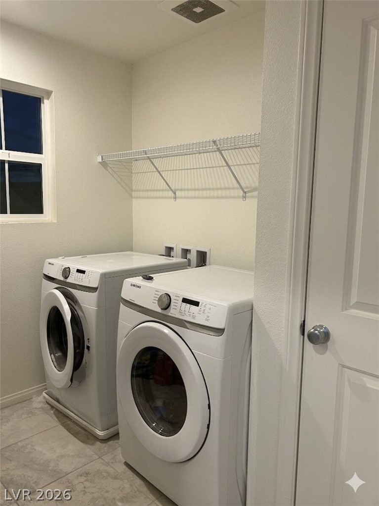 10638 Adobe Rnch Street Las Vegas, NV 89141 - Photo 27 of 35 Laundry area featuring washer and dryer and baseboards