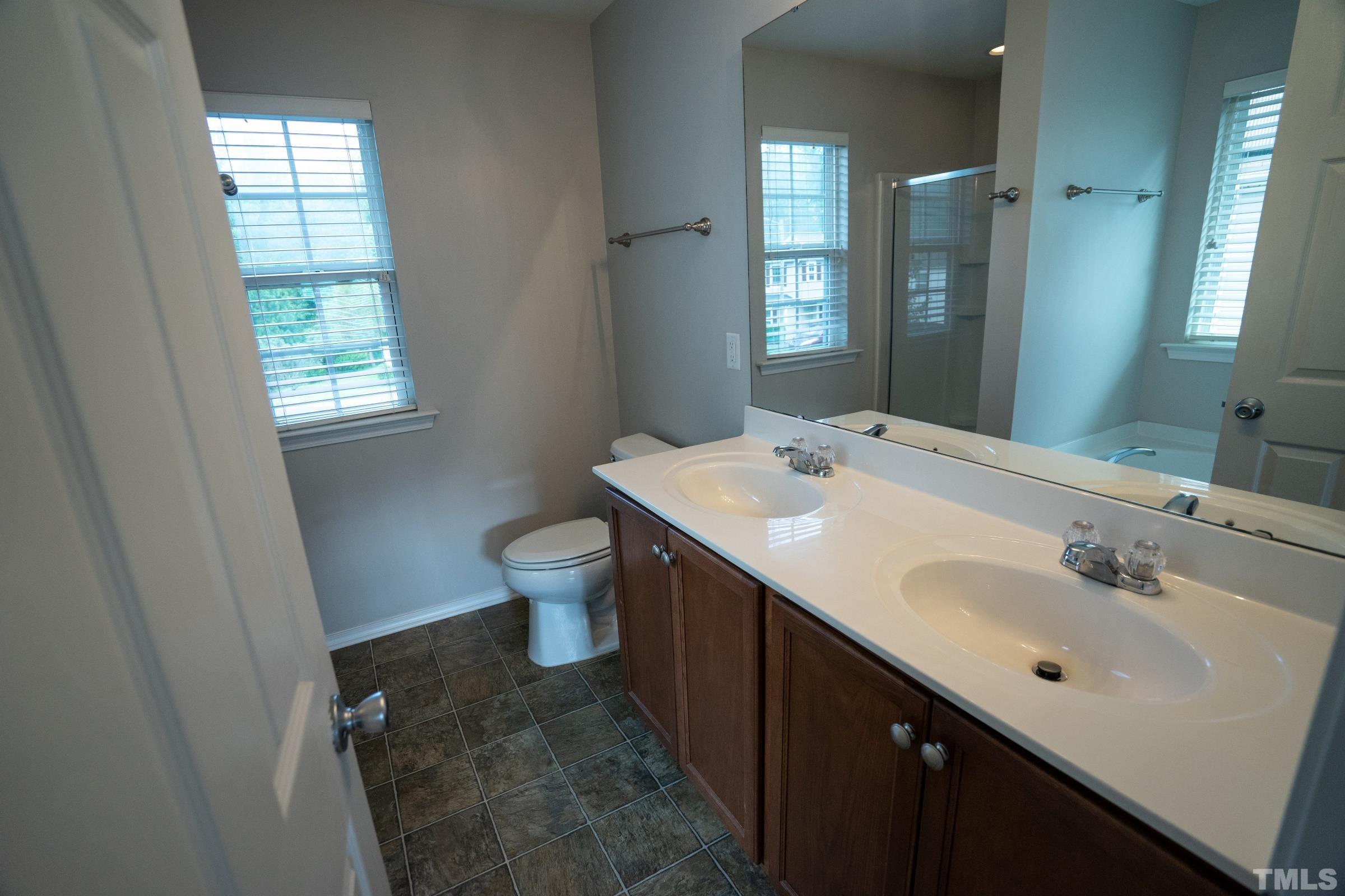 3 Mint Hill Court Durham, NC 27703 - Photo 11 of 19 a bathroom with a sink and a mirror