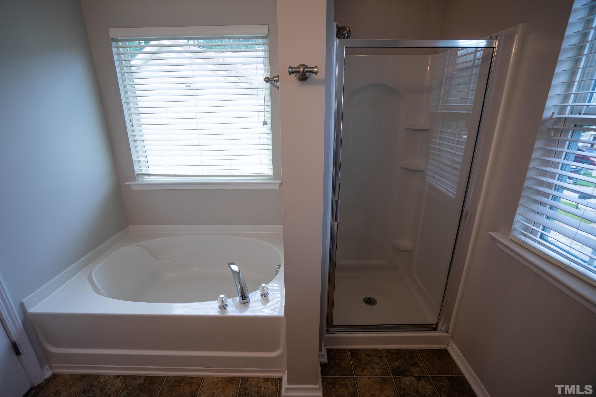 3 Mint Hill Court Durham, NC 27703 - Photo 12 of 19 a bathroom with bathtub and window
