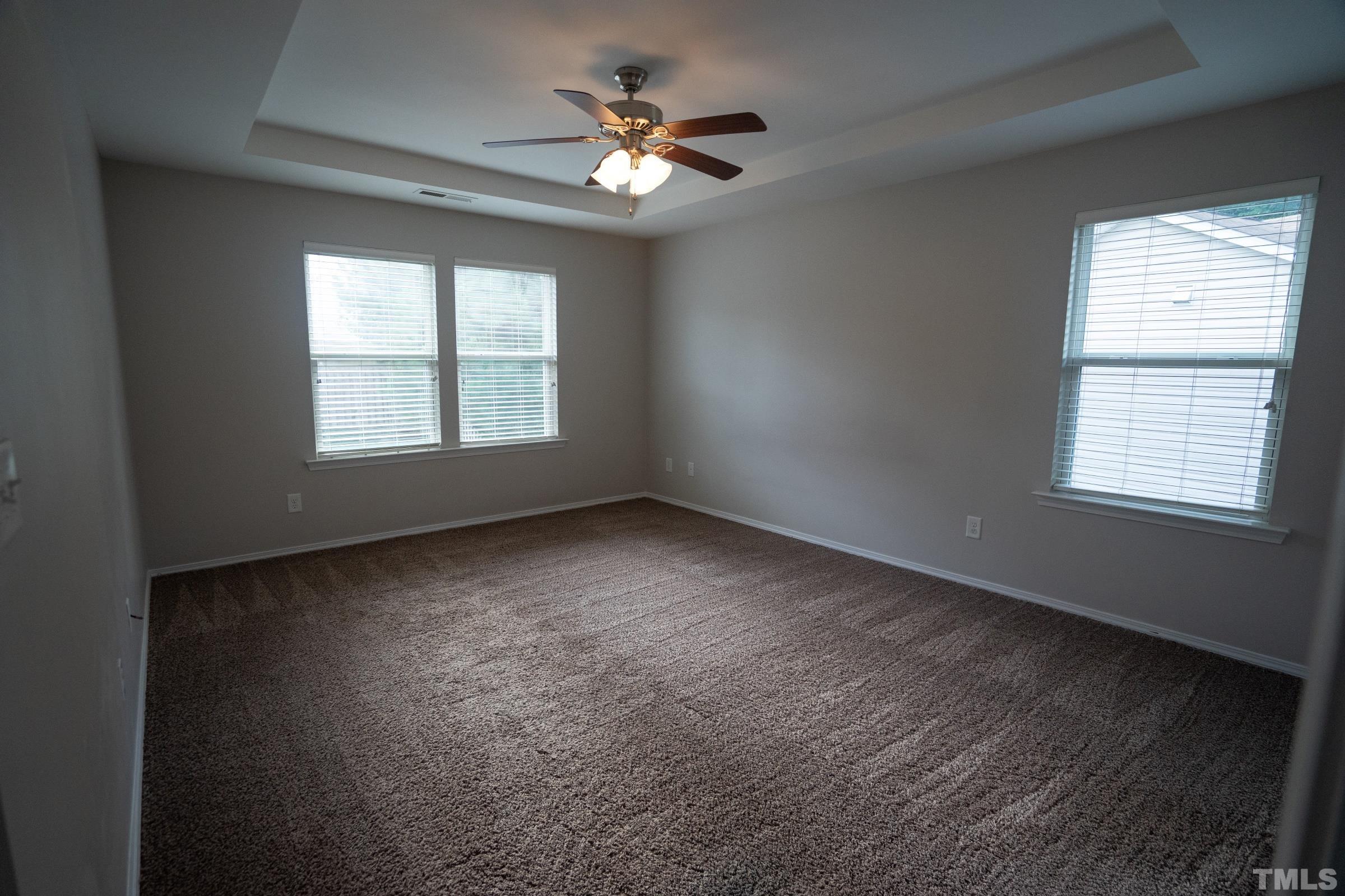 3 Mint Hill Court Durham, NC 27703 - Photo 13 of 19 an empty room with a window and a ceiling fan