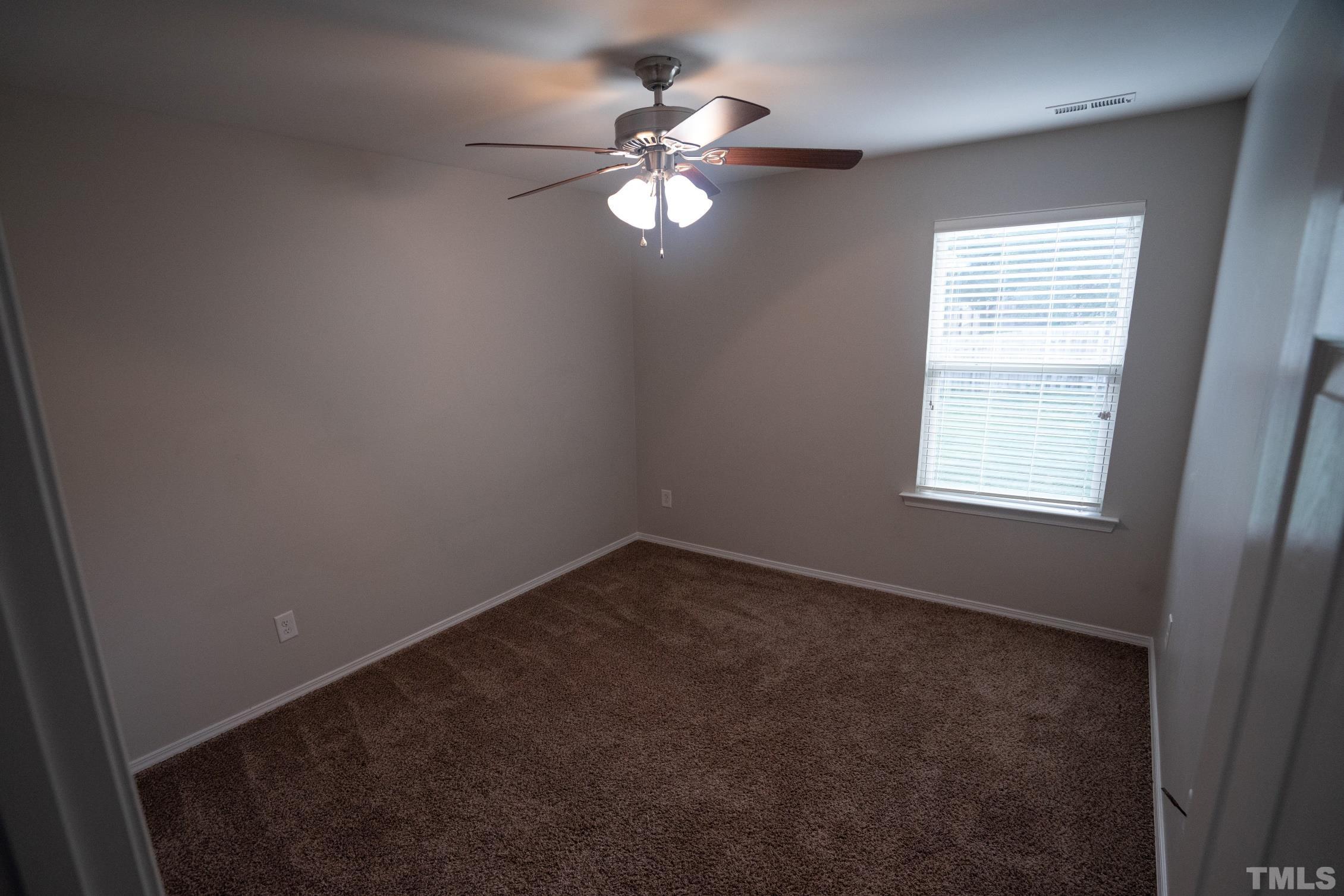 3 Mint Hill Court Durham, NC 27703 - Photo 14 of 19 an empty room with windows and fan