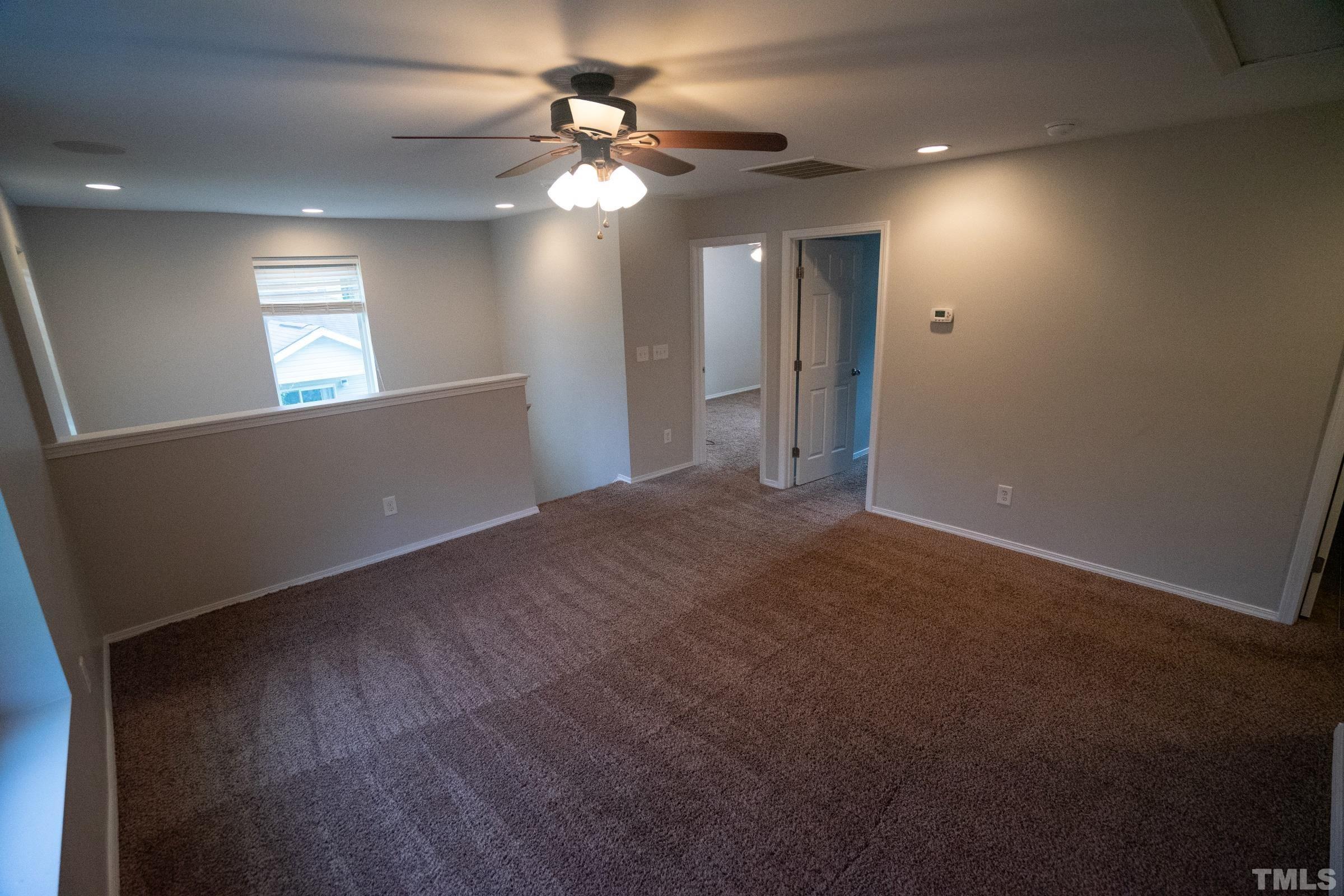 3 Mint Hill Court Durham, NC 27703 - Photo 7 of 19 en empty room with windows and fan