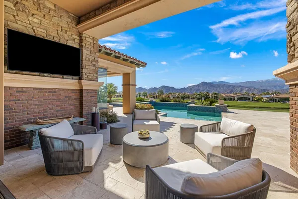a view of a patio with couches chairs and a fire pit