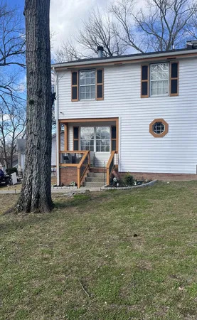 a view of a house with a backyard