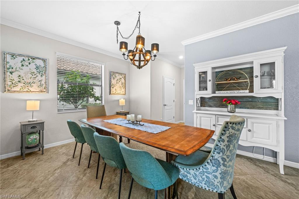 4754 Abaca Circle Naples, FL 34119 - Photo 13 of 46 a view of a dining room with furniture window and wooden floor