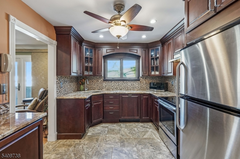 27 Espy Road, Unit A7 Caldwell, NJ 07006 - Photo 7 of 29 a kitchen with stainless steel appliances granite countertop a sink stove and refrigerator