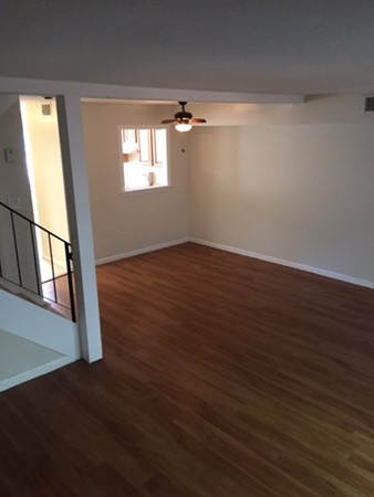 20 F Beal's Cove Road, Unit F Hingham, MA 02043 - Photo 3 of 3 an empty room with wooden floor and windows