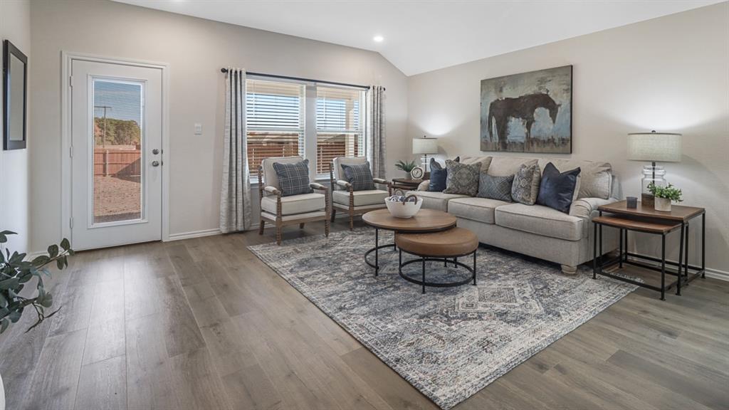 1667 Mantle Road Crandall, TX 75114 - Photo 7 of 20 Spacious living area featuring wood-finish flooring, vaulted ceilings, and a neutral color palette