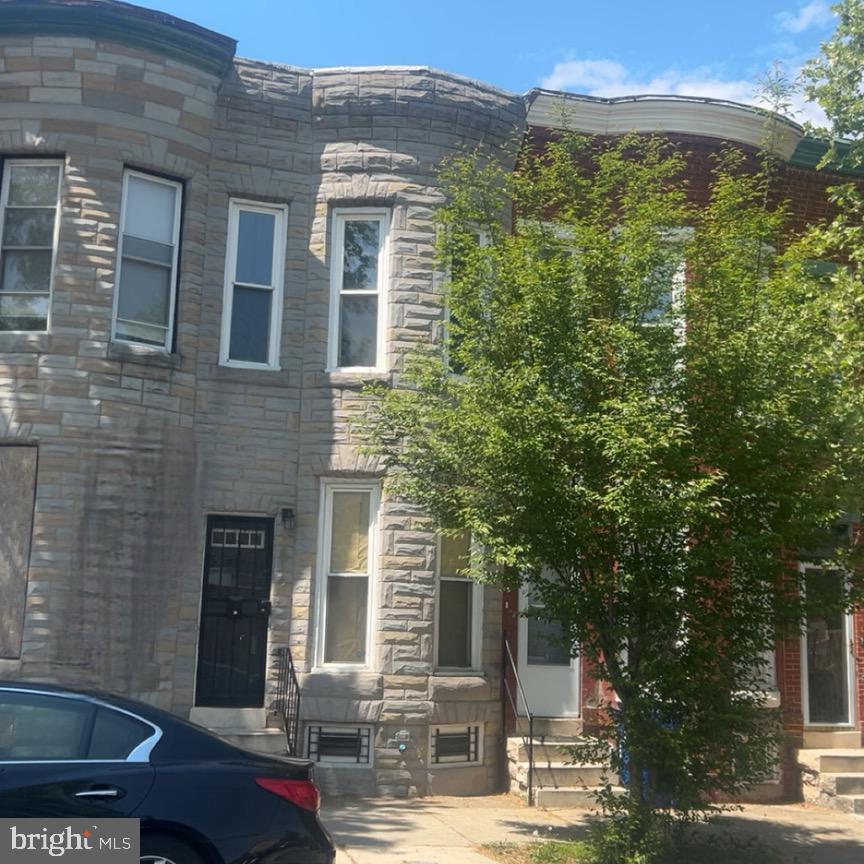 1516 North Mount Street Baltimore, MD 21217 - Photo 26 of 30 a front view of a house with a yard