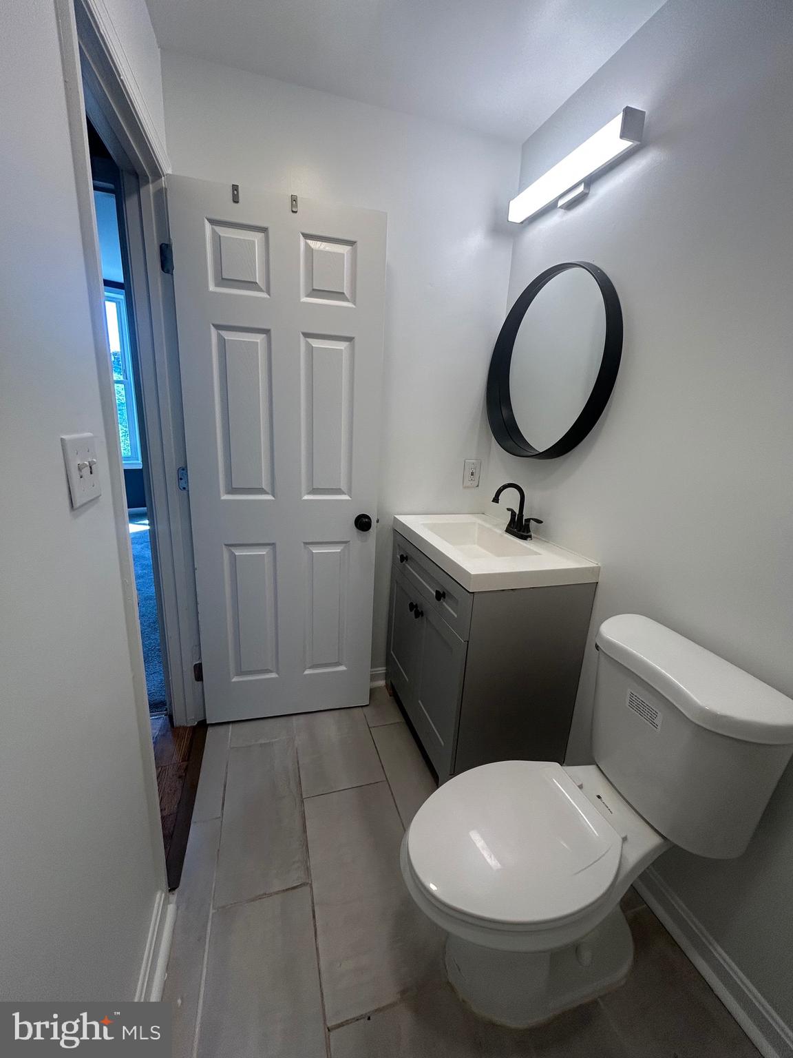1516 North Mount Street Baltimore, MD 21217 - Photo 30 of 30 a bathroom with a toilet sink and mirror